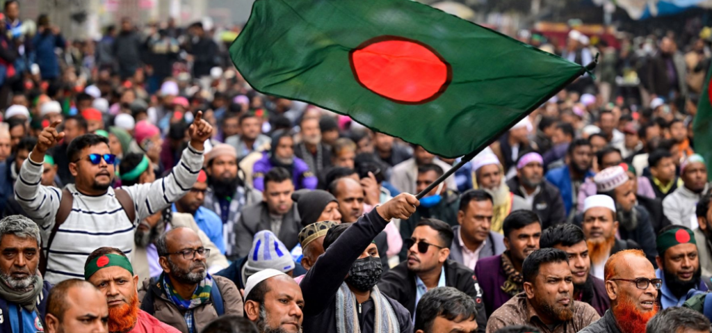 Massive political rally in Dhaka ahead of the Bangladesh Election 2026. Supporters of the BNP and Jamaat-e-Islami waving flags and chanting slogans, reflecting the intense political rivalry and anti-incumbency sentiment.
