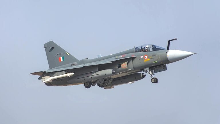 Indian Air Force Tejas fighter jet soaring in clear blue skies, demonstrating agility and speed.
