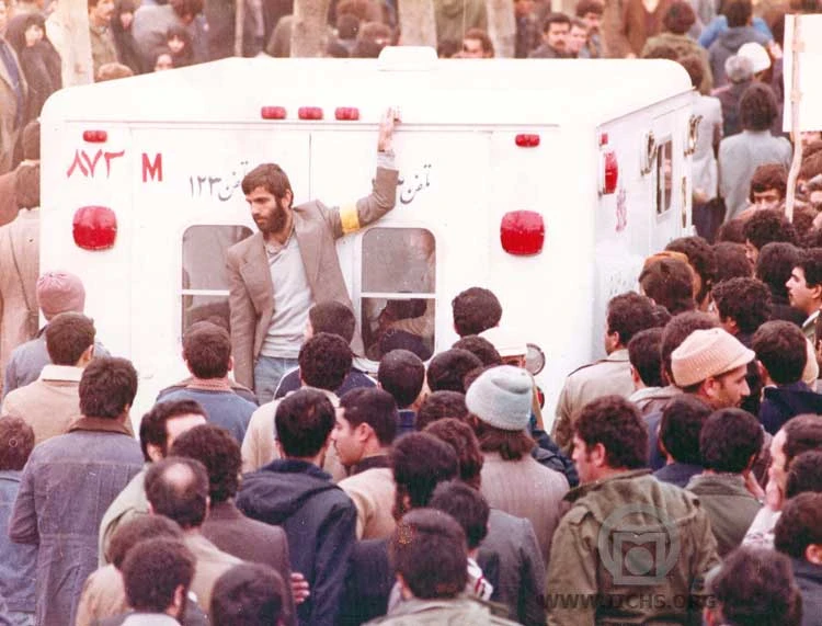 Demonstrators and an ambulance during unrest in Iran