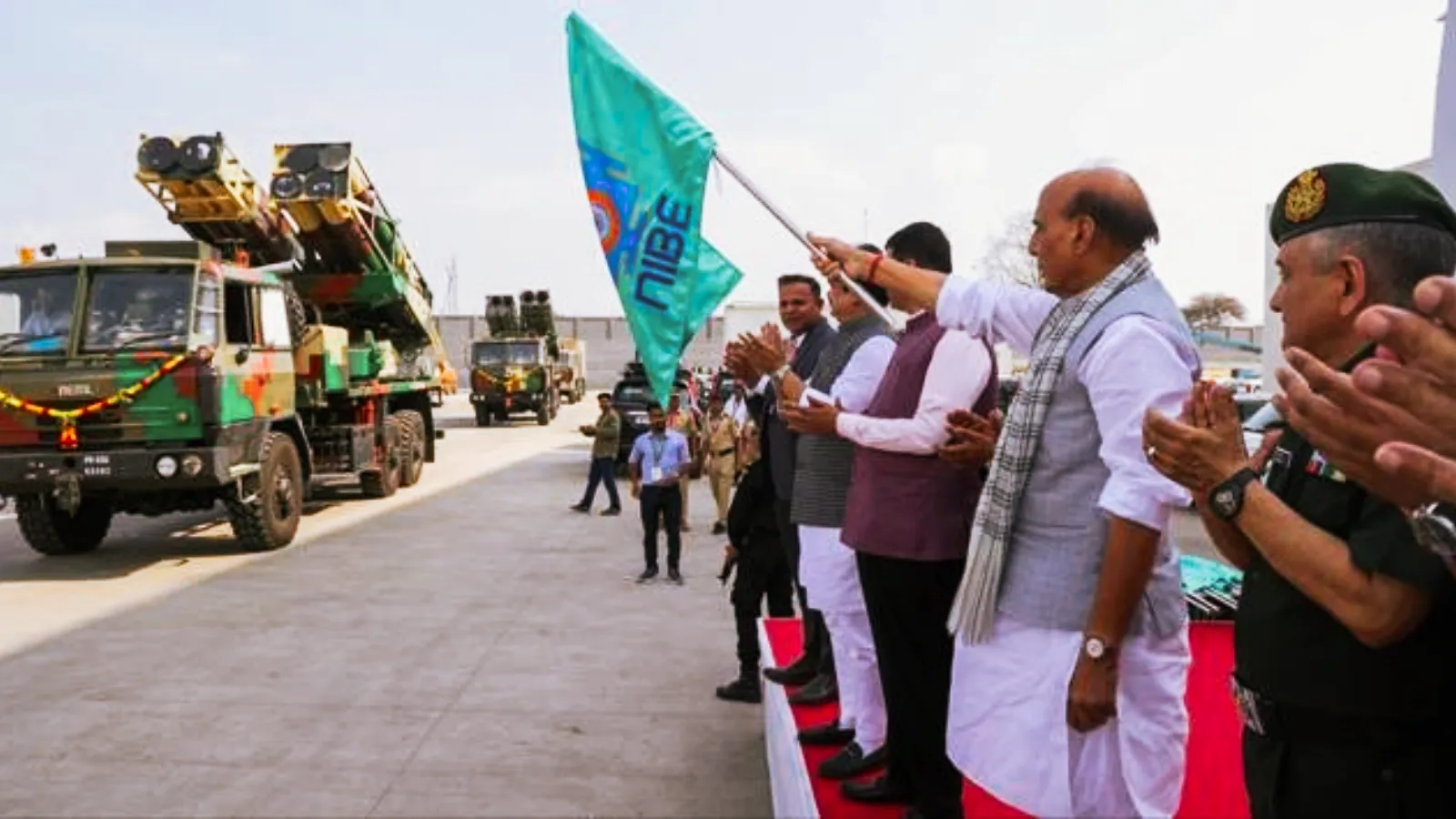 defence minister rajnath singh showing green flag to NIBE Limited Suryastra rocket system 